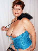 Plump mature taking off her blue corset and showing pussy