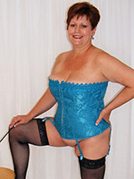 Plump mature taking off her blue corset and showing pussy