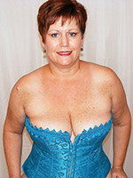 Plump mature taking off her blue corset and showing pussy